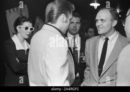 Elvis Presley speaking with fans at an adult party after his show at the Fox Theater, Detroit, Michigan, May 25, 1956. Stock Photo