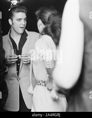 Elvis Presley speaking with a fan at an adult party after his show at the Fox Theater, Detroit, Michigan, May 25, 1956. Stock Photo