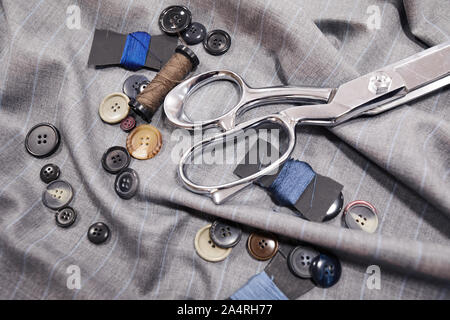Close-up of different colorful buttons scissors and fabric ready for sewing Stock Photo