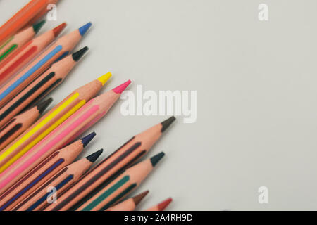 Colored pencils on the left on white background arranged obliquely Stock Photo