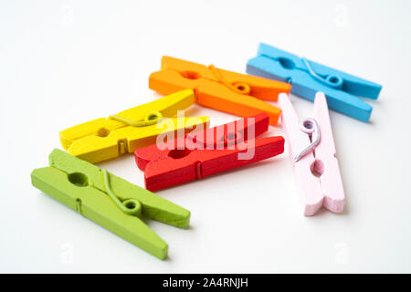 Colorful wooden clothespins on isolated white background Stock Photo