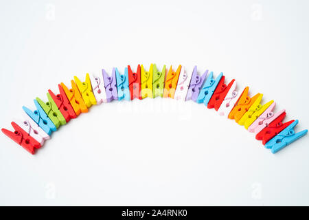 Colorful wooden clothespins on isolated white background Stock Photo