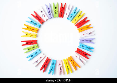 A clothespin or clothes peg is a fastener used to hang up clothes for drying, usually on a clothes line. Clothespins often come in many different desi Stock Photo