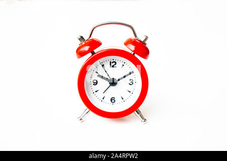 close up of a vintage red bell clock on white background Stock Photo