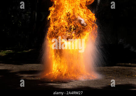 Flames caused by the explosion of the oil. Demonstration of water on oil fire. Stock Photo