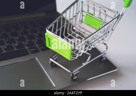 Mini supermarket trolley on the laptop keyboard Stock Photo