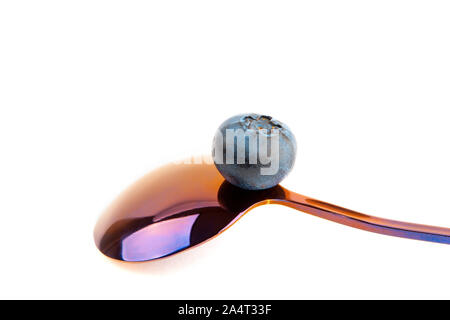 Blueberry on purple metal spoon isolated on white background Stock Photo