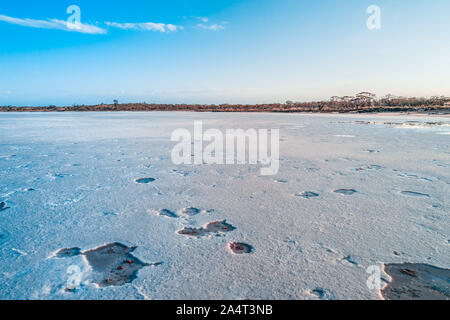 Thick crust of salt on lake surface in Australian desert Stock Photo