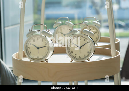 Retro styled alarm clocks on round shelf with shallow focus Stock Photo
