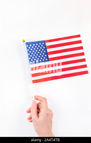 Creative top view flat lay of American flags for Elections, Memorial Day, 4th of July or Labour Day with copy space on white background in minimal sty Stock Photo