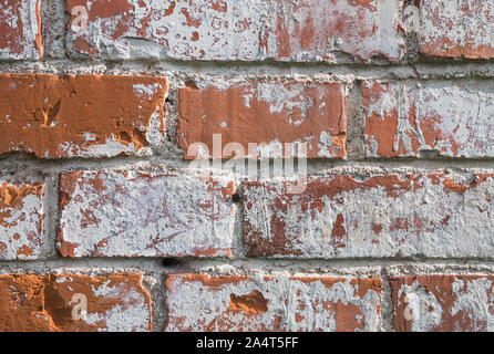 Abstract background, texture of an old red brick wall stained with white Stock Photo