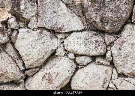 Abstract background, texture of an old stone wall made of large cobblestones Stock Photo