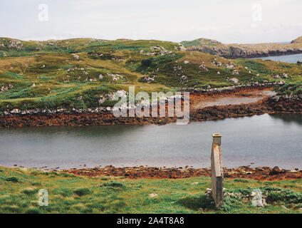 Wall of abandoned croft next to loch amongst the rugged landscape of the Isle of Lewis and Harris, Outer Hebrides, Scotland Stock Photo