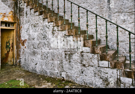 Weathered steps, door, wall and metal railing Stock Photo