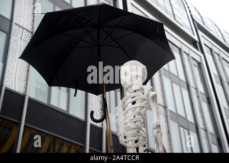 London October 12th 2019  Extinction Rebellion Funeral March from Marble Arch. Skeleton with umbrella. Stock Photo