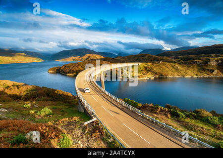 The Kylesku Bridge spanning Loch a' Chàirn Bhàin in the Scottish Highlands and a landmark on the North Coast 500 tourist driving route Stock Photo