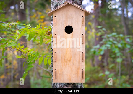 Birdhouse for forest birds on a tree Stock Photo