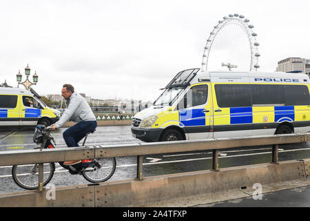London, UK - 16 October 2019.  Police vans stationed on Westminster Bridge after a section 14 public order was issued banning protest by climate activists from Extinction Rebellion which has thretened to challenge the ban in the High Courts. Credit: amer ghazzal/Alamy Live News