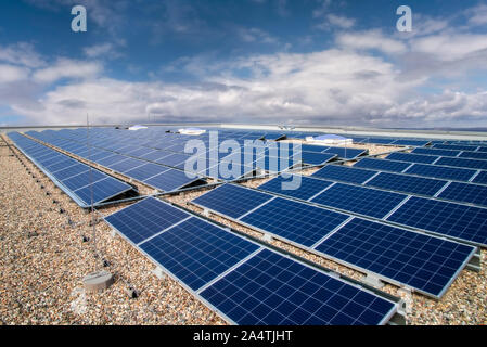 On the roof of a commercial property installed photovoltaic system Stock Photo