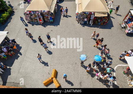 Elevated view of a street market in the historic centre of the famous town of Pisa with stands selling souvenir to tourists in summer, Tuscany, Italy Stock Photo