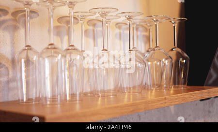 Lots of wine glasses on shelf. Empty wine glasses Stock Photo