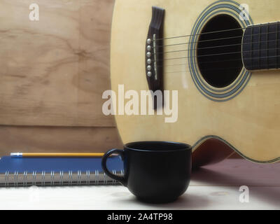 Coffee and guitar  on wooden table. Stock Photo