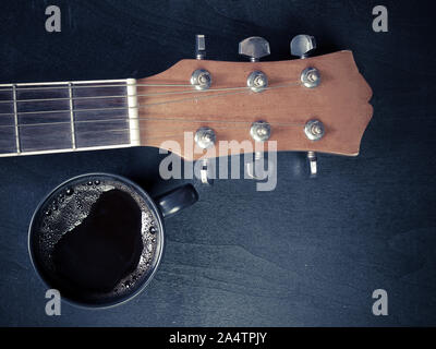 Coffee and guitar  on wooden table. (Vintage Style) Stock Photo