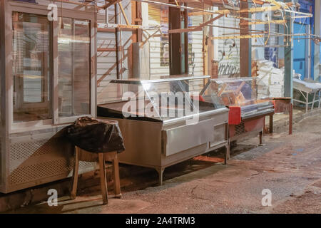 Empty butcher refrigerators on market. Night view of meat shop refrigerator equipment outside closed shops at Kapani Market in Thessaloniki Greece. Stock Photo