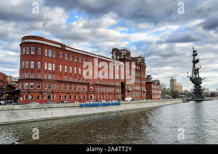 MOSCOW,RUSSIA - MARCH 11,2014: Building of Red October chocolate factory on the Bersenevskaya embankment, Moscow River and a monument to Pertr Great Stock Photo