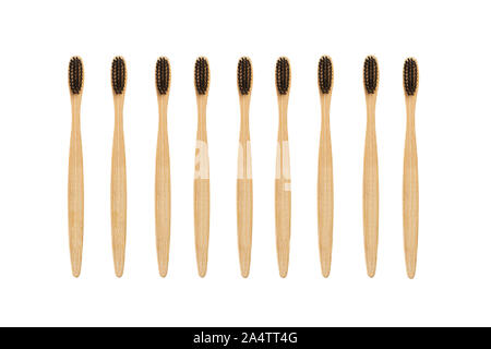 Bamboo toothbrushes with black bristles on an isolated view Stock Photo