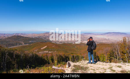 Photographer traveler on top of a mountain Stock Photo