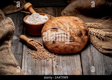 Freshly baked traditional bread on wooden table Stock Photo