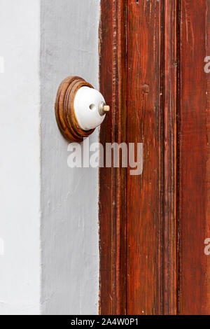 Old ceramic doorbell push button by a front door of a house in Guia de Isora, Tenerife, Canary Islands, Spain Stock Photo