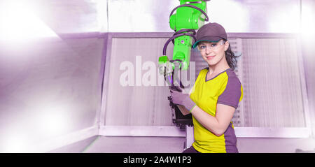 A young female technician while machine constructing in a manufacturing plant Stock Photo