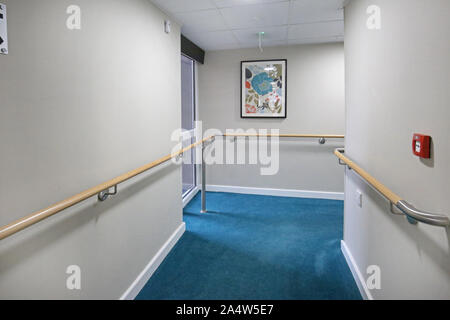 Access corridor in a newly refurbished care home near Wakefield, UK. Shows safety handrails and fire doors. Stock Photo