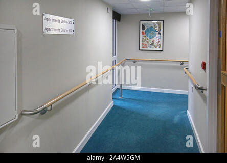 Access corridor in a newly refurbished care home near Wakefield, UK. Shows safety handrails and fire doors. Stock Photo