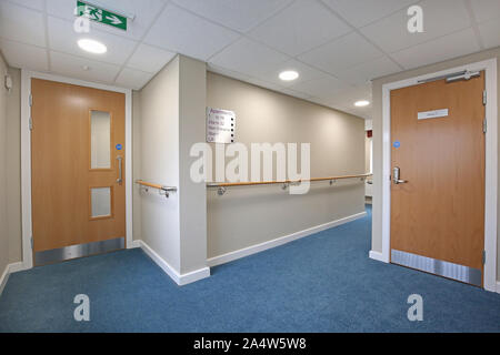 Access corridor in a newly refurbished care home near Wakefield, UK. Shows safety handrails and fire doors. Stock Photo