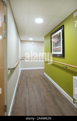 Access corridor in a newly refurbished care home near Wakefield, UK. Shows safety handrails and fire doors. Stock Photo
