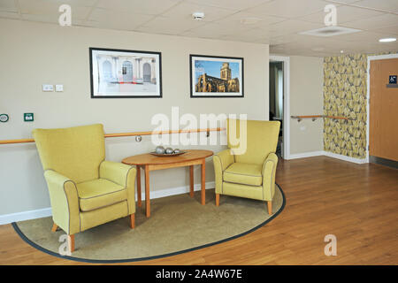 Interior of a newly refurbished care home near Wakefield, UK. Shows bright colours, wallpaper, armchairs and safety handrails. Stock Photo