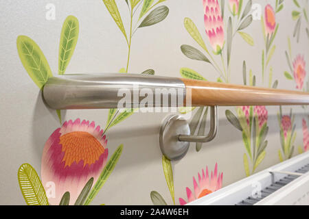Closeup of timber and brushed steel, wall mouted safety rails in a newly refurbished care home for elderly people near Wakefield, UK Stock Photo
