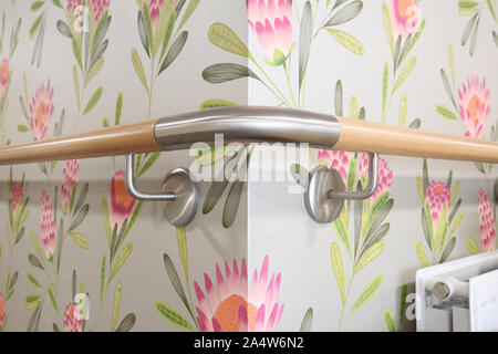 Closeup of timber and brushed steel, wall mouted safety rails in a newly refurbished care home for elderly people near Wakefield, UK Stock Photo