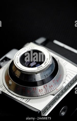 vintage retro 35mm film camera and lens on black background Stock Photo