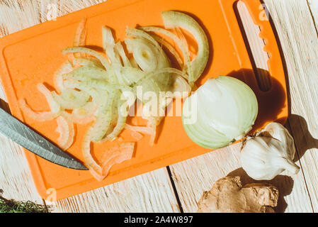 Food ingridients: red beans, carrot, cabbage, meat, onion, ginger for recipe stewed beans with meat on wooden background. Steps in cooking, process of Stock Photo
