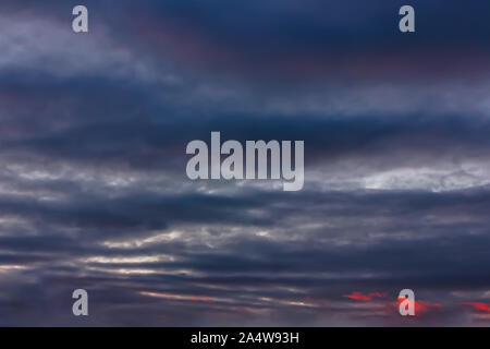 Cumulus clouds lit by the rays of the setting sun. Stock Photo