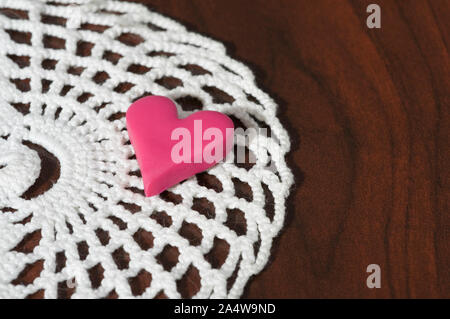 Small heart on lace doily Stock Photo