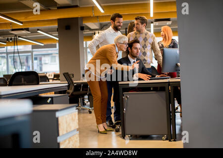Senior businesswoman and young business people work in a modern office Stock Photo