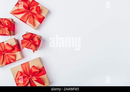 Frame of cardboard gift boxes with red bows. Stock Photo