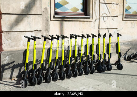 electric kick scooters from scooter-sharing system parked on a sidewalk in Warsaw, Poland Stock Photo