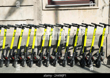 electric kick scooters from scooter-sharing system parked on a sidewalk in Warsaw, Poland Stock Photo