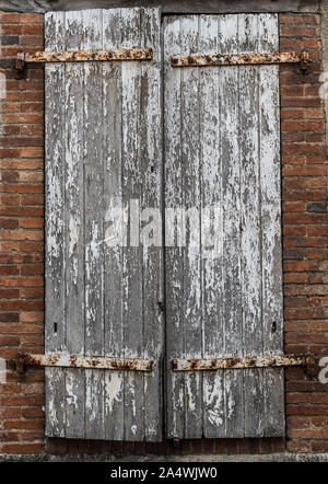 Close up on Closed old  weathered  window shutters in rural France Stock Photo